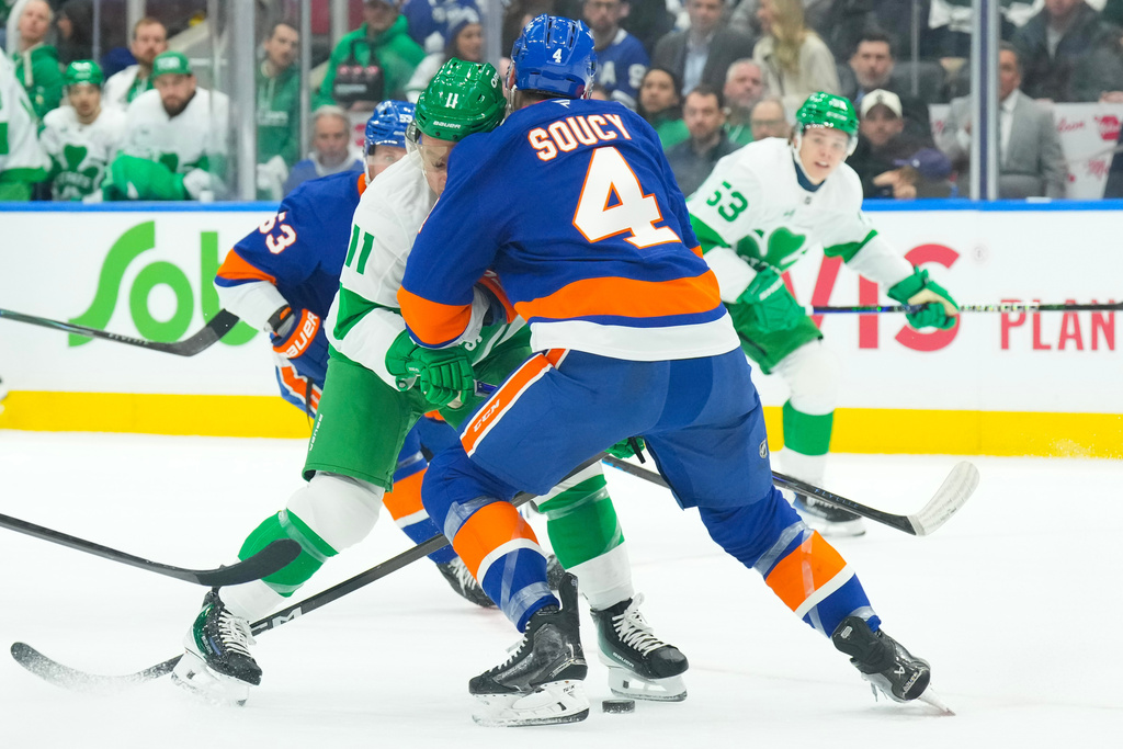 Toronto Maple Leafs' Max Domi (11) runs into New York Islanders' Carson Soucy (4) during second period NHL hockey action in Toronto, on Tuesday March 17, 2026. (Chris Young/The Canadian Press via AP)