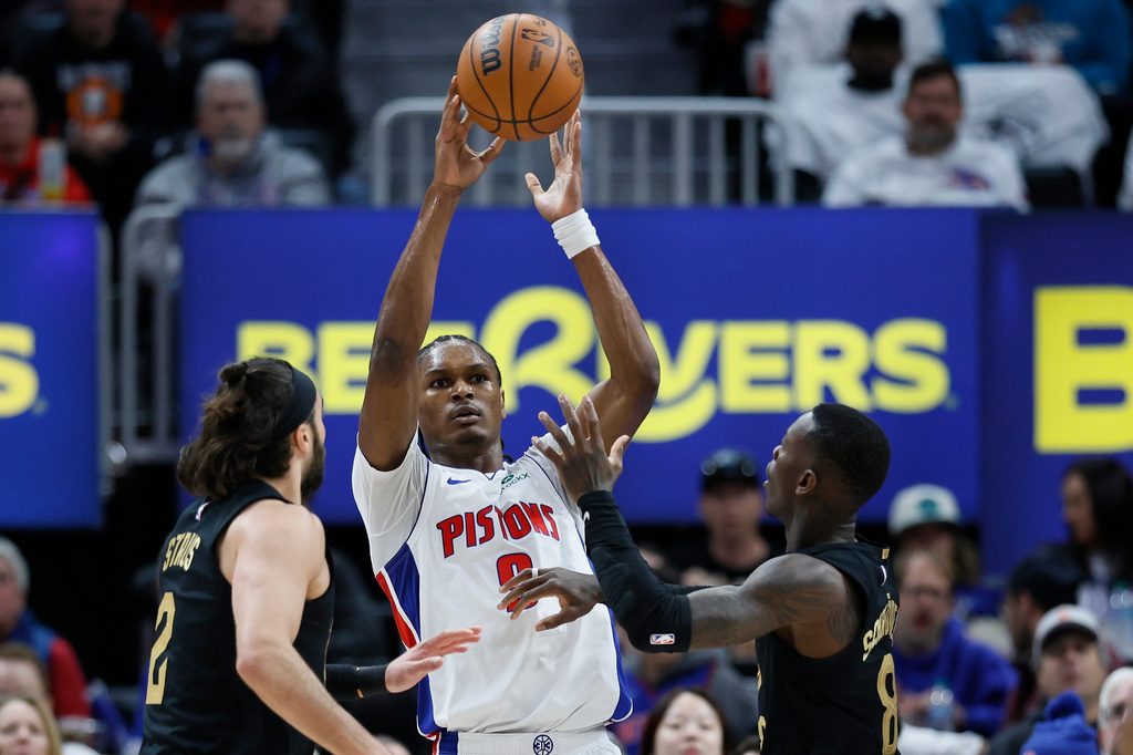 Detroit Pistons guard Ausar Thompson (9) passes the ball against Cleveland Cavaliers guard Max Strus (2) and guard Dennis Schroder (8) during the first half in Game 1 of a second-round NBA playoffs basketball series Tuesday, May 5, 2026, in Detroit. (AP Photo/Duane Burleson)