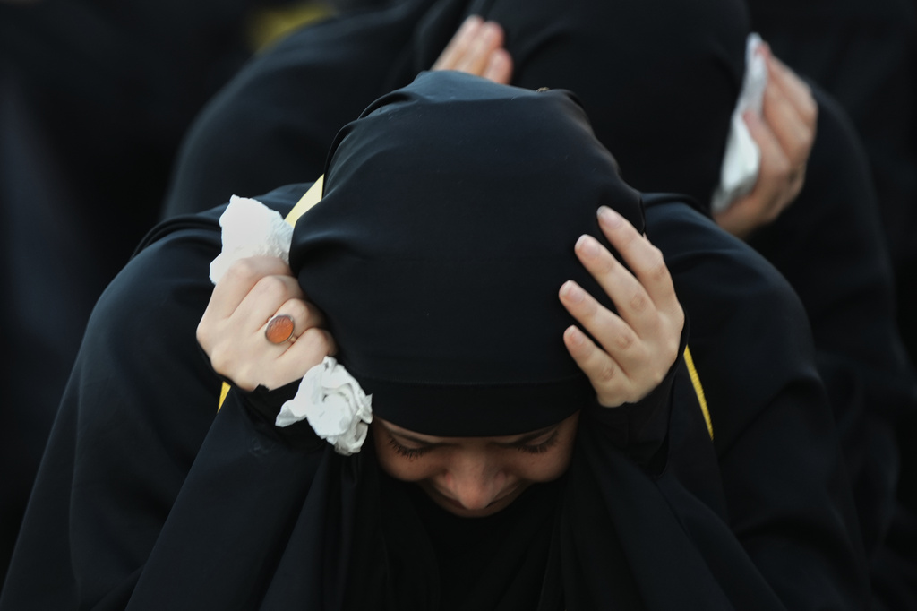 A woman mourns during a sermon marking the third day of Ashoura, the Shiite Muslim commemoration of the 7th-century death of Imam Hussein, the grandson of the Prophet Muhammad, in the southern port city of Tyre, Lebanon, Friday, June 19, 2026. (AP Photo/Hassan Ammar)