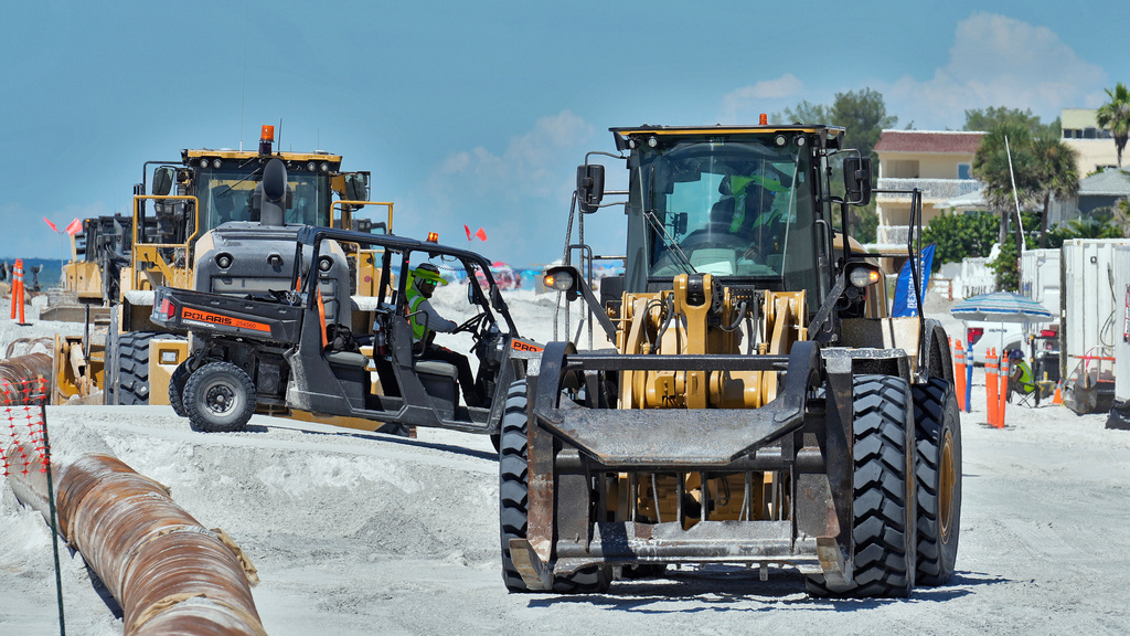 Workers replace the sand washed away by recent hurricanes along the gulf Thursday, Sept. 25, 2025, in Indian Rocks Beach, Fla. (AP Photo/Chris O'Meara)