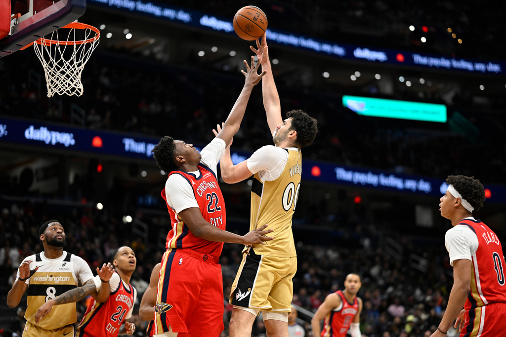 Washington Wizards forward Tristan Vukcevic, center right, goes to shoot over New Orleans Pelicans center Derik Queen (22) during the first half of an NBA basketball game, Friday, Jan. 9, 2026, in Washington. (AP Photo/John McDonnell)