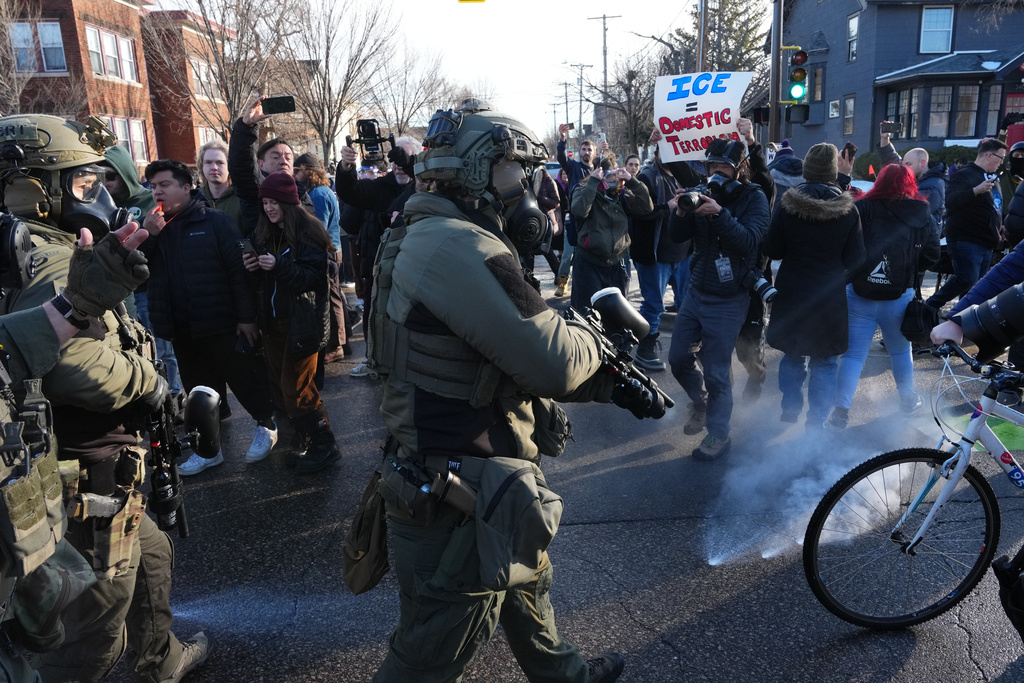 Tear gas is deployed amid protesters near the scene where Renee Good was fatally shot by an ICE officer last week, Tuesday, Jan. 13, 2026, in Minneapolis.(AP Photo/Adam Gray)