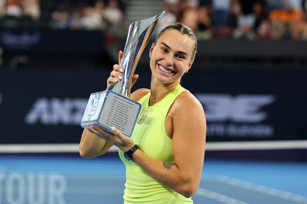 Aryna Sabalenka of Belarus poses with the winners trophy after winning the women's final match against Marta Kostyuk of Ukraine 6-4, 6-3, at the Brisbane International tennis tournament in Brisbane, Australia, Sunday, Jan. 11, 2026. (AP Photo/Tertius Pickard)