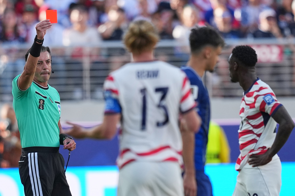 Referee Raphael Claus of Brazil shows a red card to United States' Folarin Balogun, right, during the World Cup round of 32 soccer match between the United States and Bosnia in Santa Clara, Calif., near San Francisco, Wednesday, July 1, 2026. (AP Photo/Julio Cortez)
