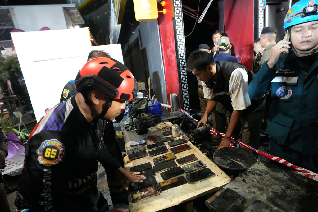 Mobile phones of victims of a fire are recovered in Bangkok, Thailand, Monday, July 13, 2026. (AP Photo/Sakchai Lalit)