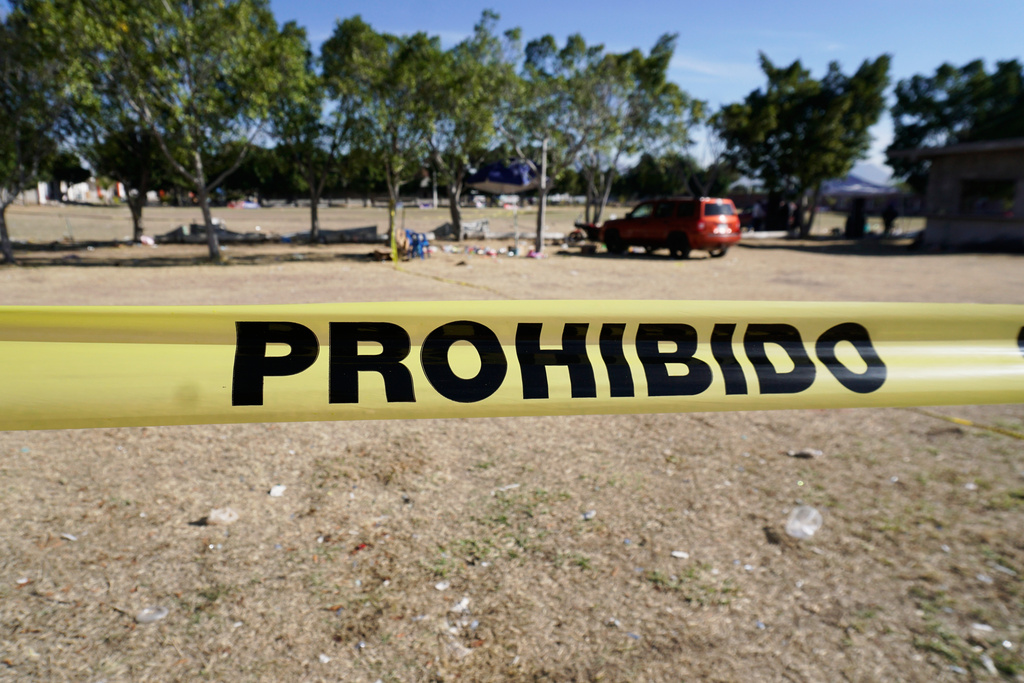 Crime scene tape surrounds a soccer field the day after gunmen opened fire, killing and wounding people, in Salamanca, Mexico, Monday, Jan. 26, 2026. (AP Photo/Mario Armas)