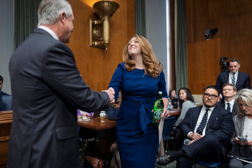 Wellness influencer and entrepreneur Dr. Casey Means is welcomed by Sen. Roger Marshall, R-Kan., left, as she appears before the Senate health committee to seek approval to be U.S. surgeon general, at the Capitol in Washington, Wednesday, Feb. 25, 2026. (AP Photo/J. Scott Applewhite)