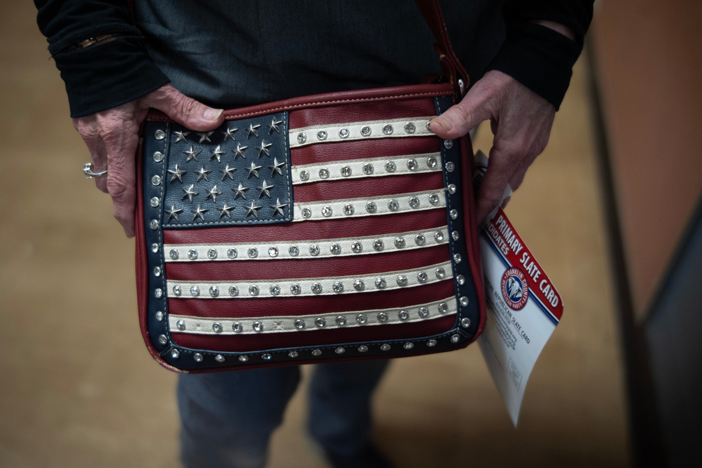 Marylou Zschach holds her American Flag purse after voting at her polling place at the Burbank Early Childhood School in Columbus, Ohio, Tuesday, May 5, 2026, during the primary election. (AP Photo/Carolyn Kaster)