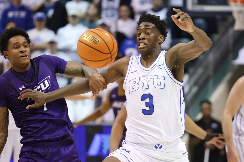 BYU forward AJ Dybantsa (3) and Abilene Christian guard Christian Alston, left, fight for a rebound during the first half of an NCAA college basketball game Friday, Dec. 19, 2025, in Provo, Utah. (AP Photo/Jeffrey D. Allred)