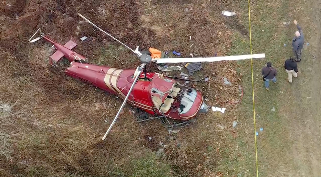 Authorities look over the scene after two helicopters crashed in Hammonton, N.J., on Sunday, Dec. 28, 2025. (WPVI-TV/6ABC via AP)
