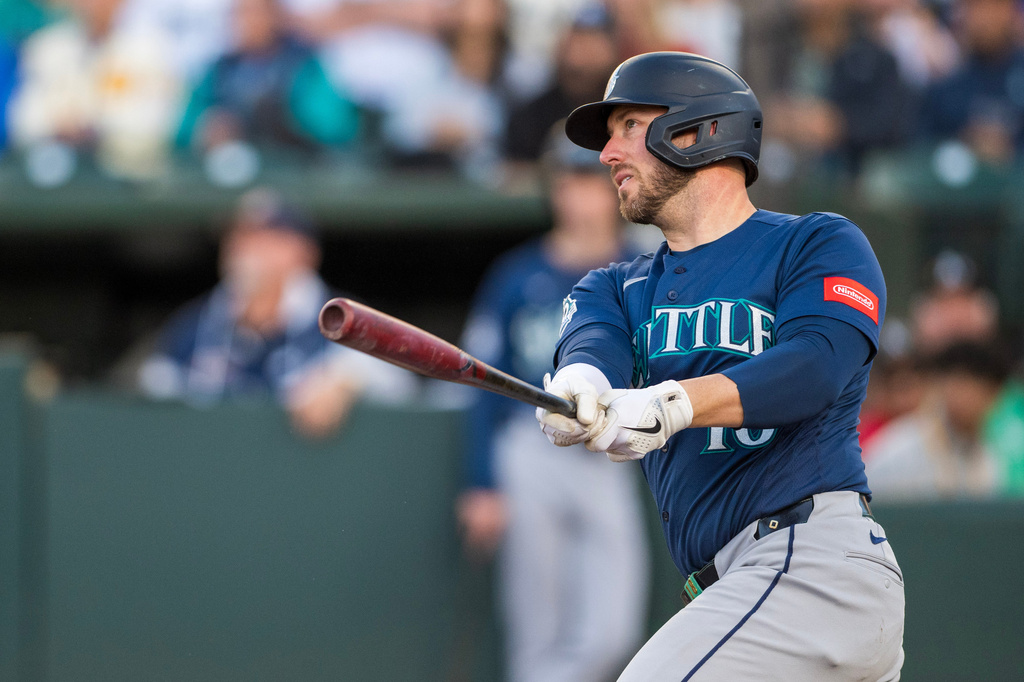 Seattle Mariners' Mitch Garver (18) hits during the third inning of a baseball game against the Athletics in West Sacramento, Calif., Tuesday, May 26, 2026. (AP Photo/Nic Coury)