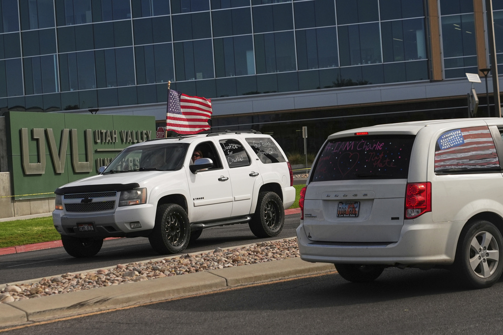 A truck drives by with "Justice for Charlie" written on a window as a brigade of vehicles drives by in tribute to Turning Point USA CEO and co-founder Charlie Kirk at Utah Valley University, Saturday, Sept. 13, 2025, in Orem, Utah. (AP Photo/Lindsey Wasson)