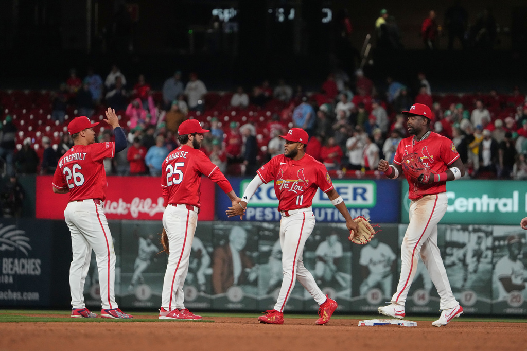 St. Louis Cardinals, from left to right, JJ Wetherholt, Thomas Saggese, Victor Scott II and Jordan Walker celebrate a victory over the Boston Red Sox following a baseball game Friday, April 10, 2026, in St. Louis. (AP Photo/Jeff Roberson)