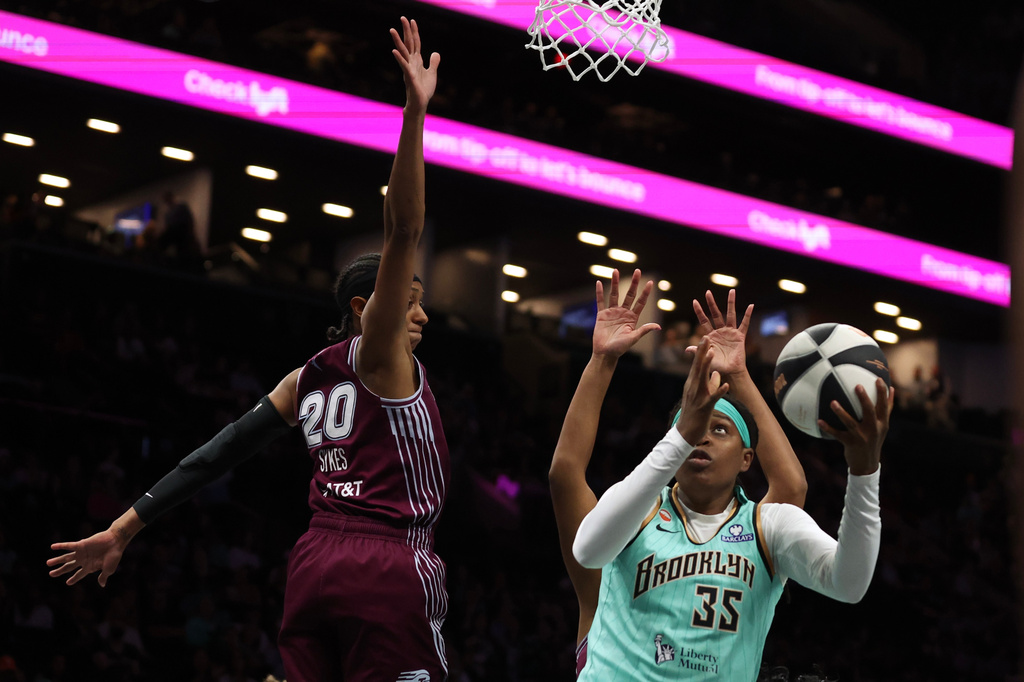 New York Liberty center Jonquel Jones (35) goes up for a shot against Toronto Tempo guard Brittney Sykes (20) during the first half of a WNBA basketball game, Wednesday, June 3, 2026, in New York. (AP Photo/Heather Khalifa)