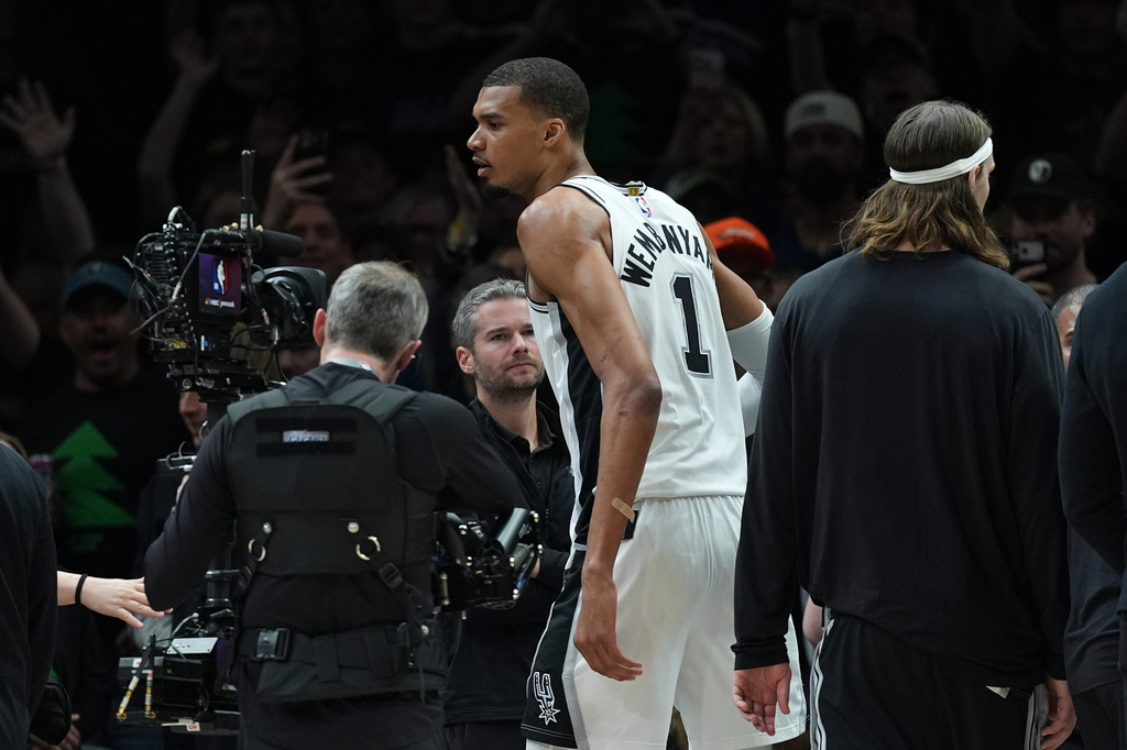 San Antonio Spurs forward Victor Wembanyama (1) reacts after he was ejected for a flagrant foul during the first half of Game 4 of an NBA basketball second-round playoffs series against the Minnesota Timberwolves in Minneapolis, Sunday, May 10, 2026. (AP Photo/Abbie Parr)
