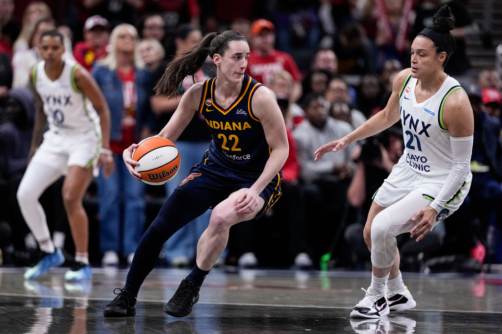 Minnesota Lynx guard Kayla McBride (21) defends Indiana Fever guard Caitlin Clark (22) in the first half of a WNBA basketball game in Indianapolis, Tuesday, Sept. 22, 2026. (AP Photo/Michael Conroy)