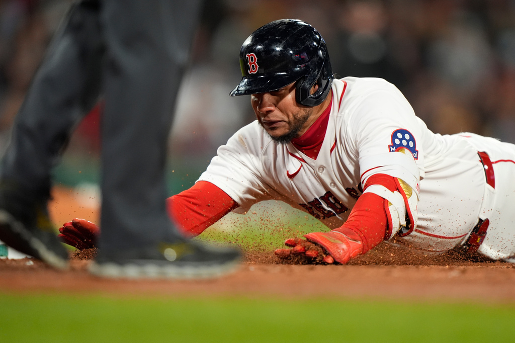 Boston Red Sox Willson Contreras dives back to first base after hitting a single in the fourth inning of a baseball game against the Milwaukee Brewers Tuesday, April 7, 2026, in Boston. (AP Photo/Robert F. Bukaty)