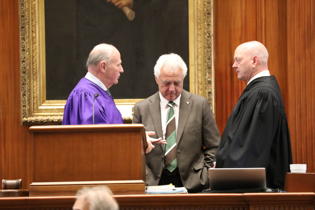Republican South Carolina Senate President Thomas Alexander, left, Republican Sen. Larry Grooms, center, and Senate Clerk Jeffrey Gossett, right, talk during a break in the Senate's redistricting debate on Friday, May 22, 2026, in Columbia, S.C. (AP Photo/Jeffrey Collins)