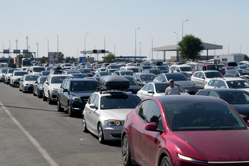 Motorists wait to cross the Serbian border from Croatia, at Batrovci border crossing, Serbia, Friday, July 31, 2026. (AP Photo/Darko Vojinovic)