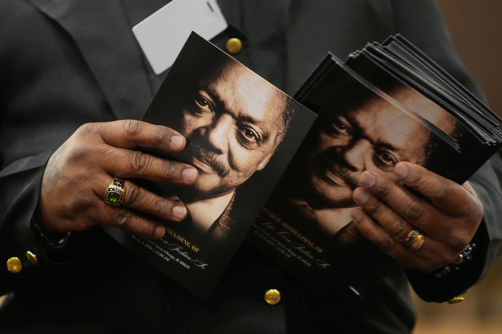 A person hands out programs during the Public Homegoing Service for Rev. Jesse Jackson at the House of Hope in Chicago, Friday, March 6, 2026.(AP Photo/Erin Hooley) (AP Photo/Erin Hooley)