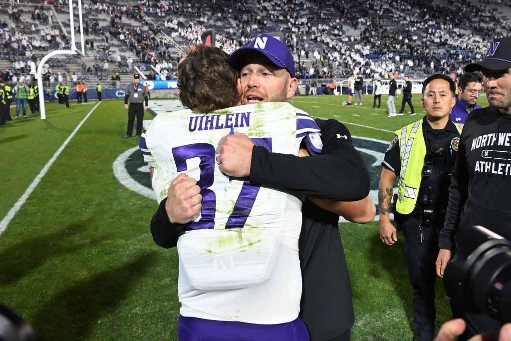 Northwestern head coach David Braun celebrate with linebacker Mac Uihlein (37) following their win over Penn State during an NCAA college football game, Saturday, Oct. 11, 2025, in State College, Pa. (AP Photo/Barry Reeger)