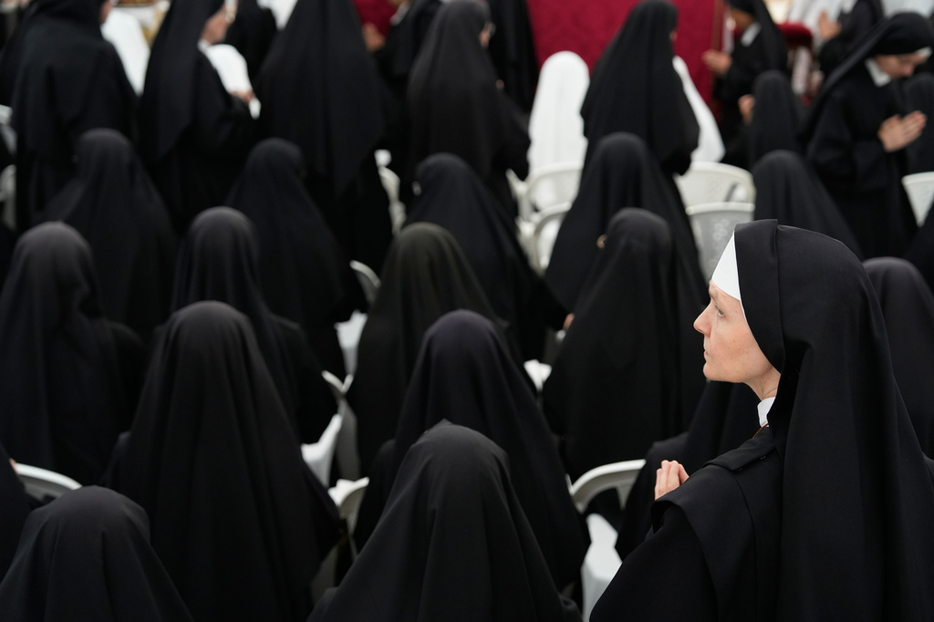 Nuns attend a consecration ceremony for four new bishops in a tent set up outside the Society of St. Pius X seminary, in Econe, Switzerland, Wednesday, July 1, 2026. (AP Photo/Baz Ratner)