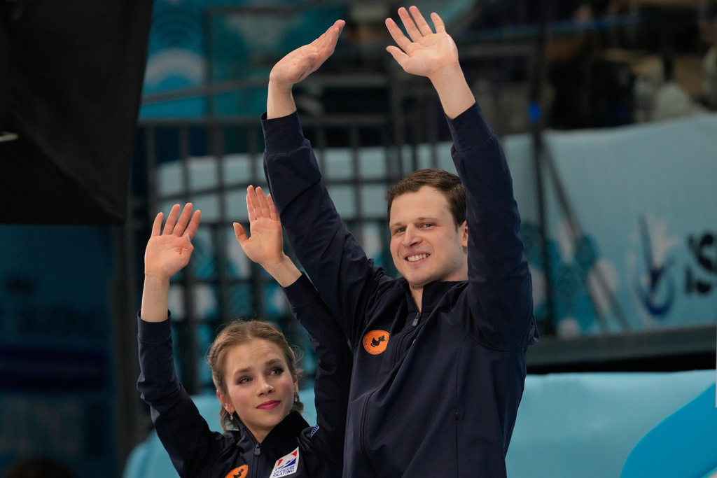 Gold medalists Alisa Efimova and Misha Mitrofanov of the United States react after the Pairs Free Skating of the ISU Four Continents Figure Skating Championships in Beijing, China, Saturday, Jan. 24, 2026. (AP Photo/Vincent Thian)