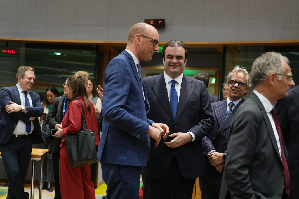 Belgium's Finance Minister Vincent Van Peteghem, center left, speaks with Greece's Finance Minister Kyriakos Pierrakakis, center right, during a meeting of eurozone finance ministers at the EU Council building in Brussels, Thursday, Dec. 11, 2025. (AP Photo/Virginia Mayo)