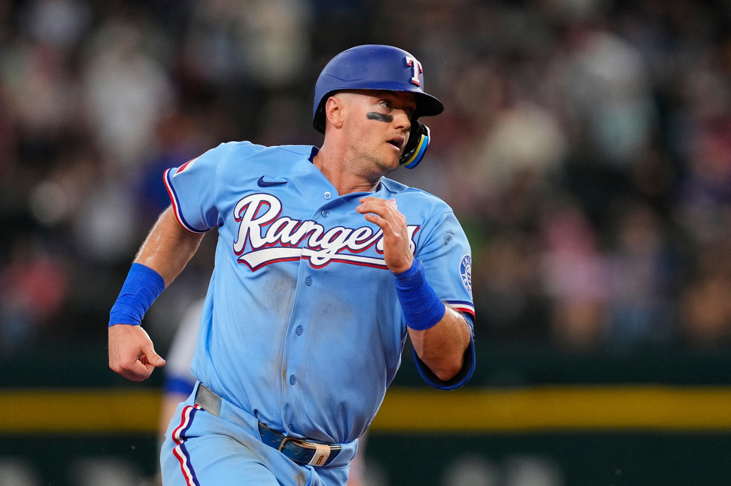 Texas Rangers' Josh Jung advances the third on a Joc Pederson double in the fourth inning of a baseball game against the Chicago Cubs Sunday May 10, 2026, in Arlington, Texas. (AP Photo/Tony Gutierrez)