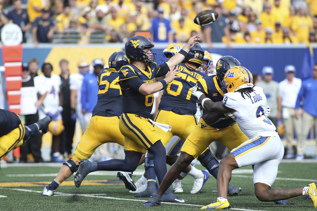 West Virginia quarterback Nicco Marchiol (8) passes during the first half of an NCAA college football game against Pittsburgh, Saturday, Sept. 13, 2025, in Morgantown, W.Va. (AP Photo/Kathleen Batten)