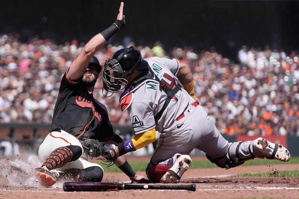 San Francisco Giants' Bryce Eldridge, left, is tagged out at home by Arizona Diamondbacks catcher Gabriel Moreno during the fourth inning of the first baseball game of a doubleheader, Saturday, Aug. 29, 2026, in San Francisco. (AP Photo/Jeff Chiu)