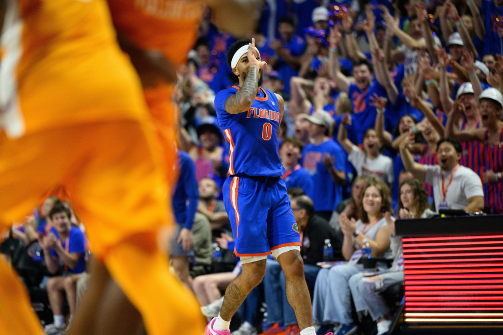 Florida guard Boogie Fland (0) celebrates a three point shot during the second half of an NCAA college basketball game against Tennessee, Saturday, Jan. 10, 2026, in Gainesville, Fla. (AP Photo/Noah Lantor)
