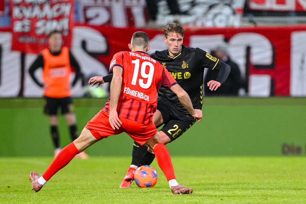 Heidenheim's Jonas Föhrenbach and Köln's Sebastian Sebulonsen, right, in action during the Bundesliga soccer match between FC Heidenheim and FC Köln in Heidenheim, Germany, Saturday Jan. 10, 2026. (Harry Langer/dpa via AP)
