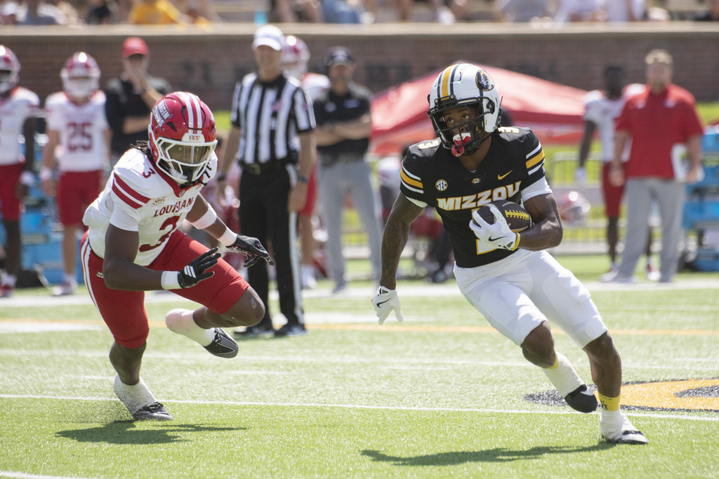Missouri wide receiver Kevin Coleman Jr., right, runs past Louisiana-Lafayette's Jaden Dugger, left, during the first half of an NCAA college football game Saturday, Sept. 13, 2025, in Columbia, Mo. (AP Photo/L.G. Patterson)