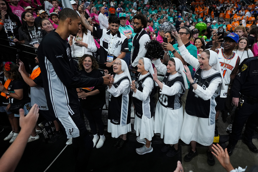 The Salesian Sisters greet players prior to Game 1 of the NBA Finals basketball series between the New York Knicks and the San Antonio Spurs, Wednesday, June 3, 2026, in San Antonio. (AP Photo/Eric Gay)
