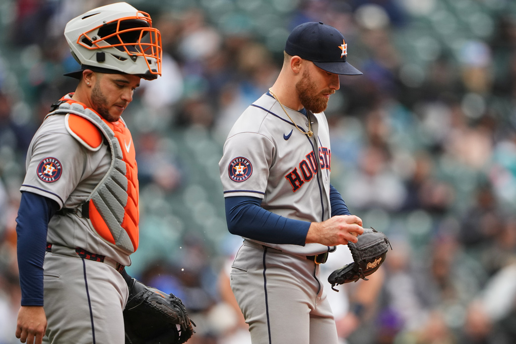 Houston Astros catcher Yainer Diaz comes to the mound to talk to starting pitcher Mike Burrows during the fifth inning of a baseball game against the Seattle Mariners, Monday, April 13, 2026, in Seattle. (AP Photo/Lindsey Wasson)