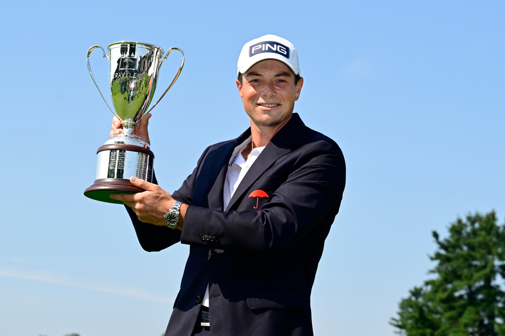 Viktor Hovland, of Norway, holds the Travelers Championship golf tournament trophy at TPC River Highlands, Monday, June 29, 2026, in Cromwell, Conn. (AP Photo/Jessica Hill)