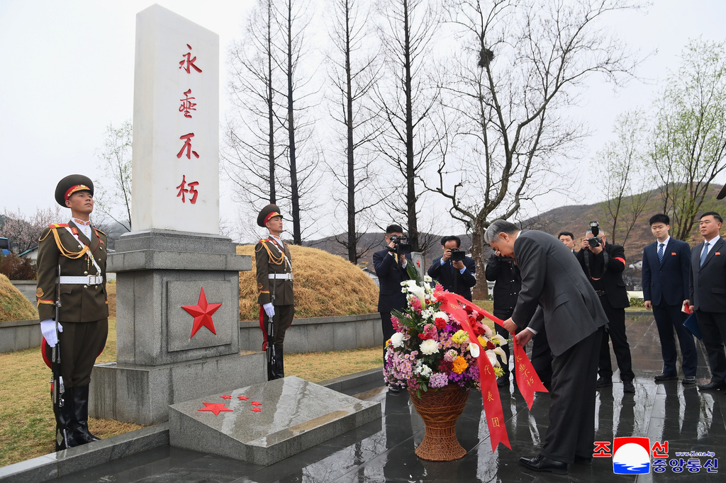 In this photo provided by the North Korean government, Chinese Foreign Minister Wang Yi, center, lays a wreath at a memorial cemetery for Chinese soldiers who participated in Korean War, during his visit, on the outskirts of Pyongyang, North Korea, Friday, April 10, 2026. Independent journalists were not given access to cover the event depicted in this image distributed by the North Korean government. The content of this image is as provided and cannot be independently verified. Korean language watermark on image as provided by source reads: "KCNA" which is the abbreviation for Korean Central News Agency. (Korean Central News Agency/Korea News Service via AP)