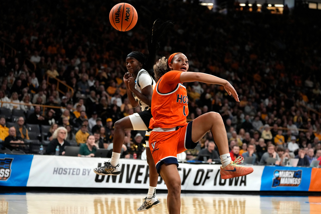 Virginia guard Paris Clark (1) fights for a loose ball with Iowa guard Chazadi Wright, left, during the first half in the second round of the NCAA college basketball tournament, Monday, March 23, 2026, in Iowa City, Iowa. (AP Photo/Charlie Neibergall)
