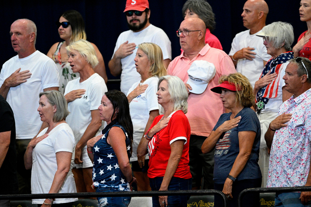 FILE - People say the Pledge of Allegiance before a visit by President Donald Trump, May 1, 2026, in The Villages, Fla. (AP Photo/Phelan M. Ebenhack, File)
