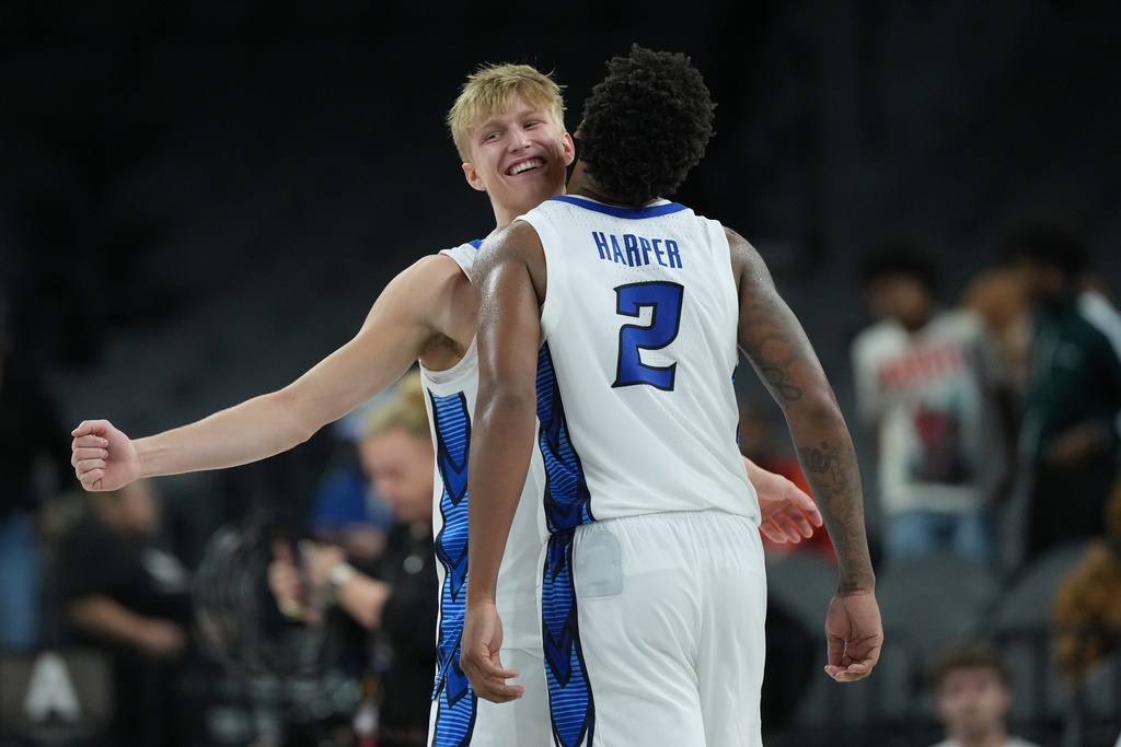 Creighton guard Ty Davis, left, and guard Blake Harper (2) celebrate their win over Oregon in an NCAA college basketball game in the Players Era tournament in Las Vegas, Thursday, Nov. 27, 2025. (AP Photo/Eric Gay)