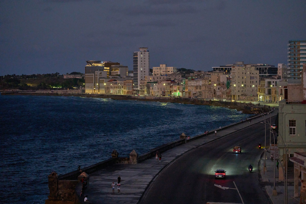 Vehicles traverse the Malecon at dusk in Havana, Wednesday, April 15, 2026. (AP Photo/Ramon Espinosa)