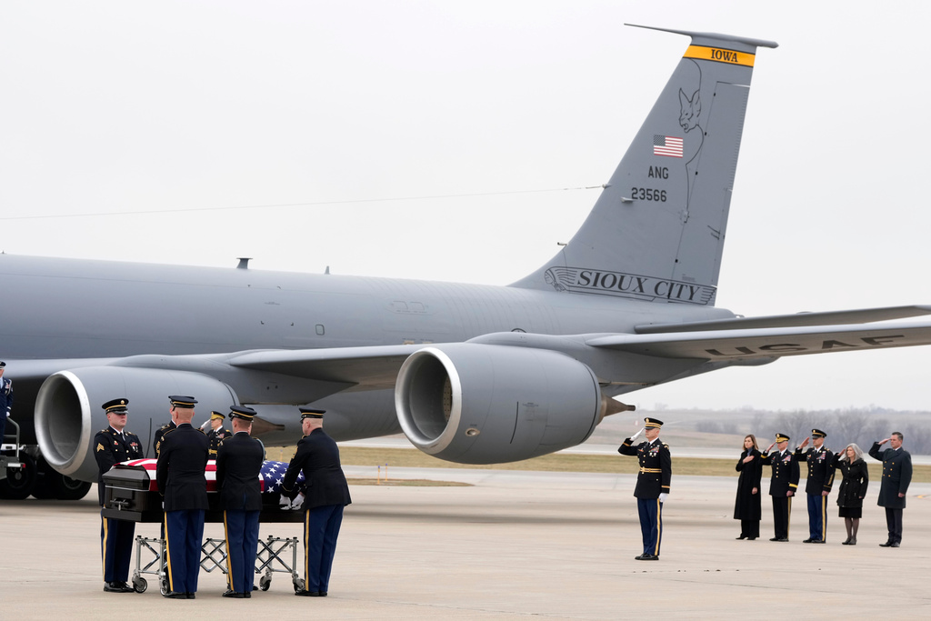The remains of Staff Sgt. William Nathaniel Howard, 29, of Marshalltown, one of the two Iowa National Guard members killed in an attack in the Syrian desert, is moved during a dignified transfer at the Des Moines International Airport in Des Moines, Iowa, Wednesday, Dec. 24, 2025. (AP Photo/Charlie Neibergall)