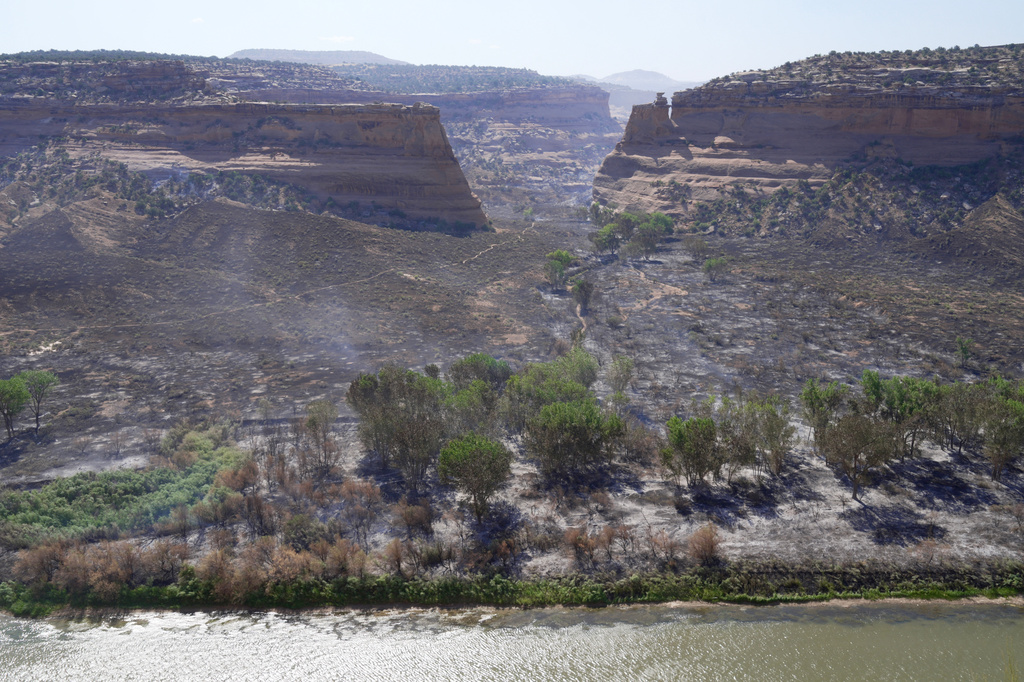 A burned section of the Snyder Fire seen from across the Colorado river in Mack, Colorado, on Sunday, June 28, 2026. (AP Photo/Ty O'Neil)
