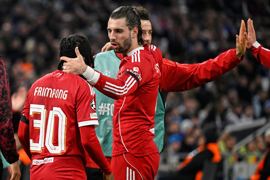 Liverpool's Jeremie Frimpong, left, and Liverpool's Dominik Szoboszlai celebrate after Marseille's goalkeeper Geronimo Rulli scored an own goal during the Champions League opening phase soccer match between Marseille and Liverpool in Marseille, France, Wednesday, Jan. 21, 2026. (AP Photo/Philippe Magoni)