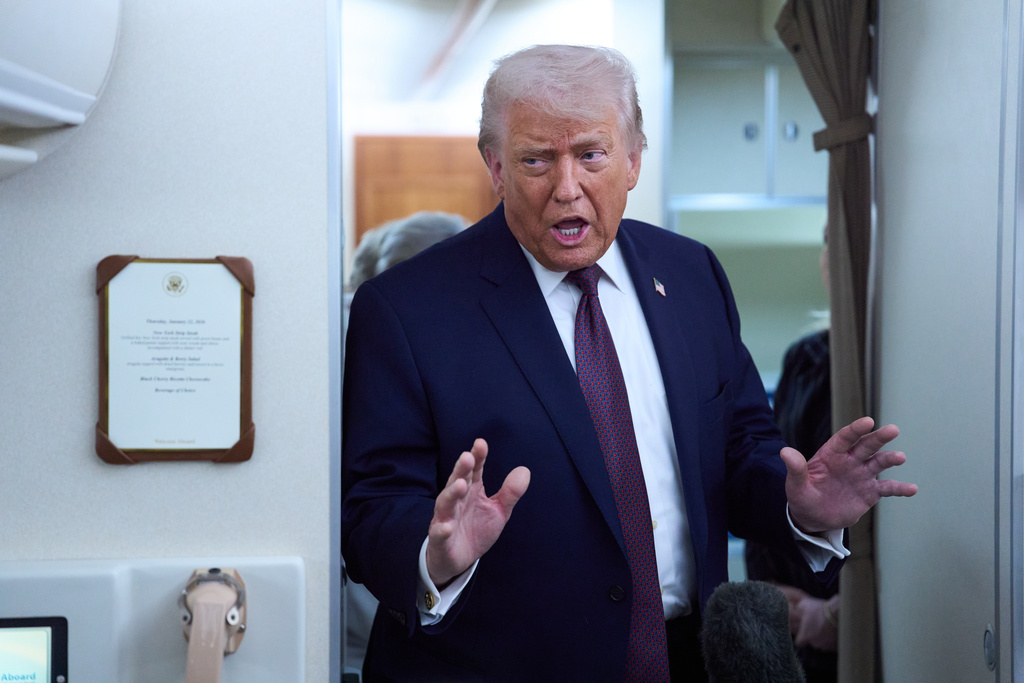 President Donald Trump speaks with reporters aboard Air Force One after leaving the World Economic Forum in Davos for Washington, Thursday, Jan. 22, 2026. (AP Photo/Evan Vucci)