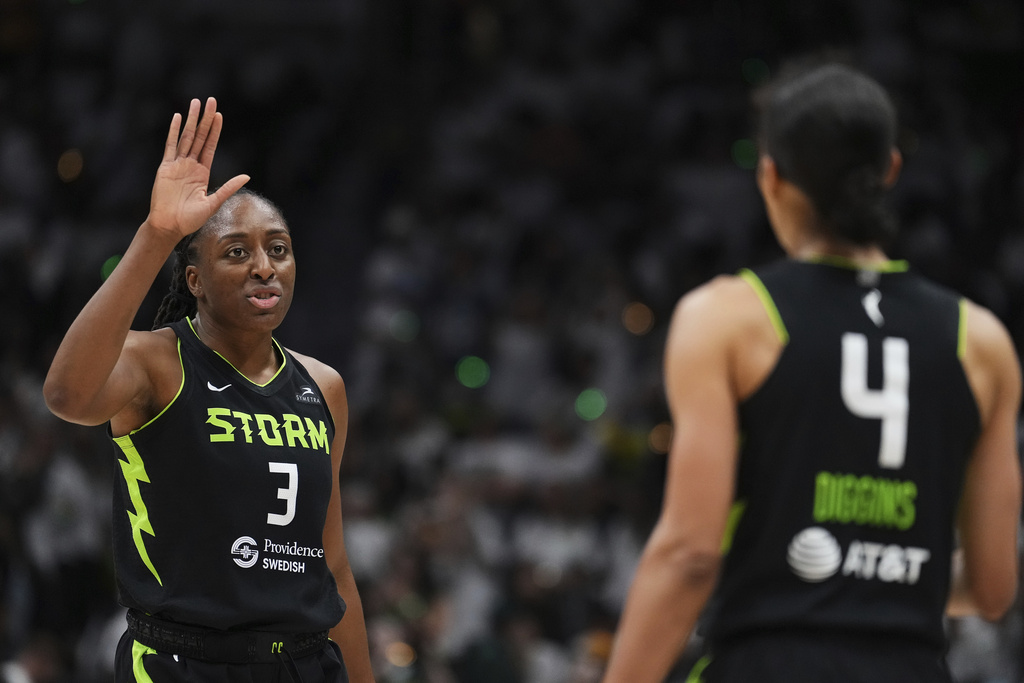 Seattle Storm forward Nneka Ogwumike greets guard Skylar Diggins (4) during the first half of Game 2 against the Las Vegas Aces in the first round of the WNBA basketball playoffs Tuesday, Sept. 16, 2025, in Seattle. (AP Photo/Lindsey Wasson)