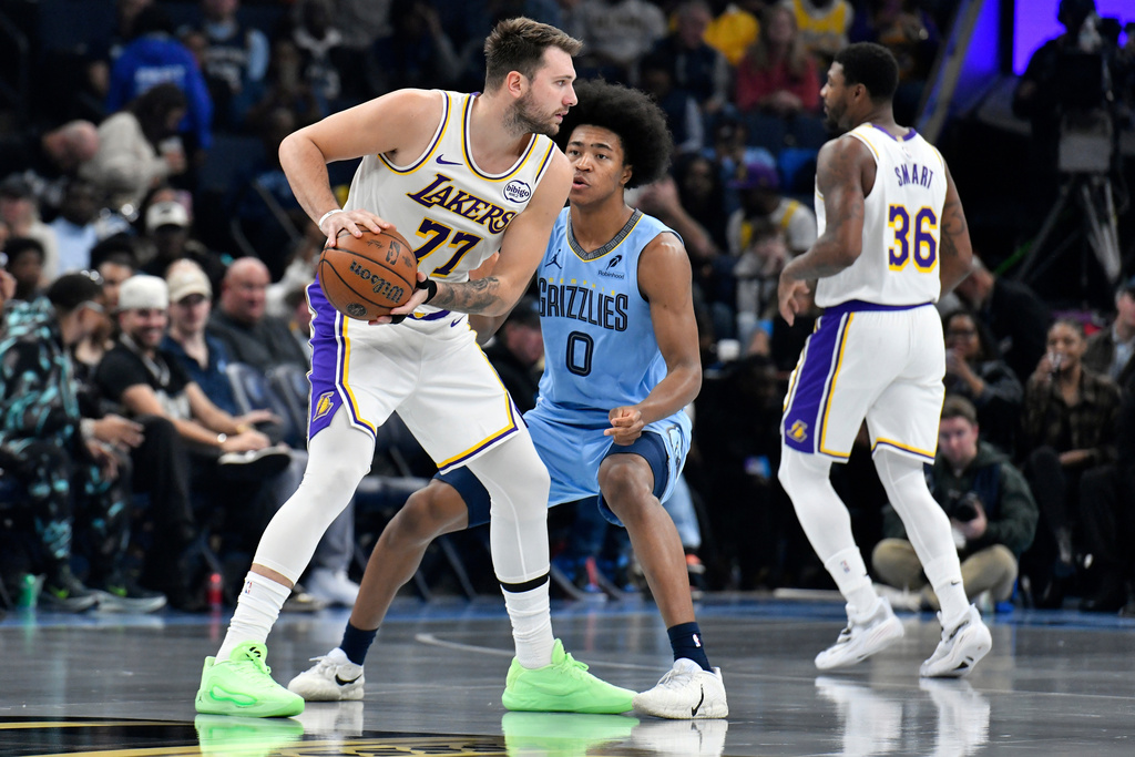 Los Angeles Lakers guard Luka Doncic (77) handles the ball against Memphis Grizzlies forward Jaylen Wells (0) in the first half of an NBA Cup basketball game Friday, Oct. 31, 2025, in Memphis, Tenn. (AP Photo/Brandon Dill)