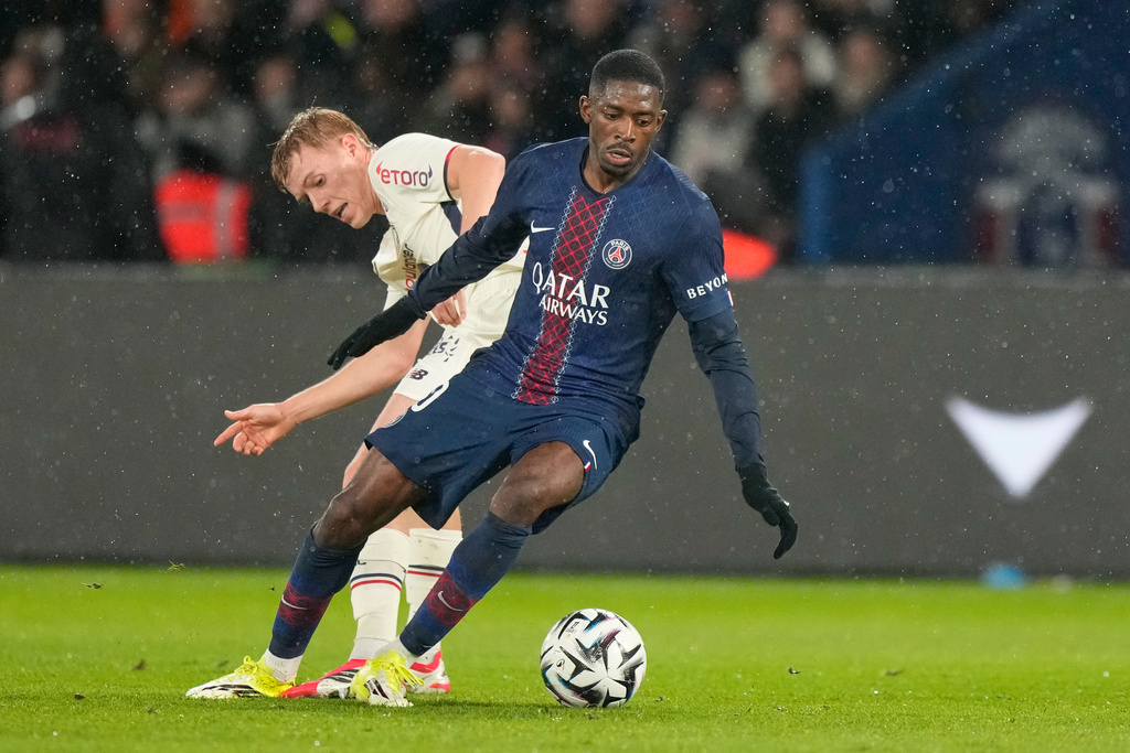 PSG's Ousmane Dembele, right, challenges for the ball with Lille's Hakon Arnar Haraldsson during the French League One soccer match between Paris Saint-Germain and Lille in Paris, France, Friday, Jan. 16, 2026. (AP Photo/Michel Euler)
