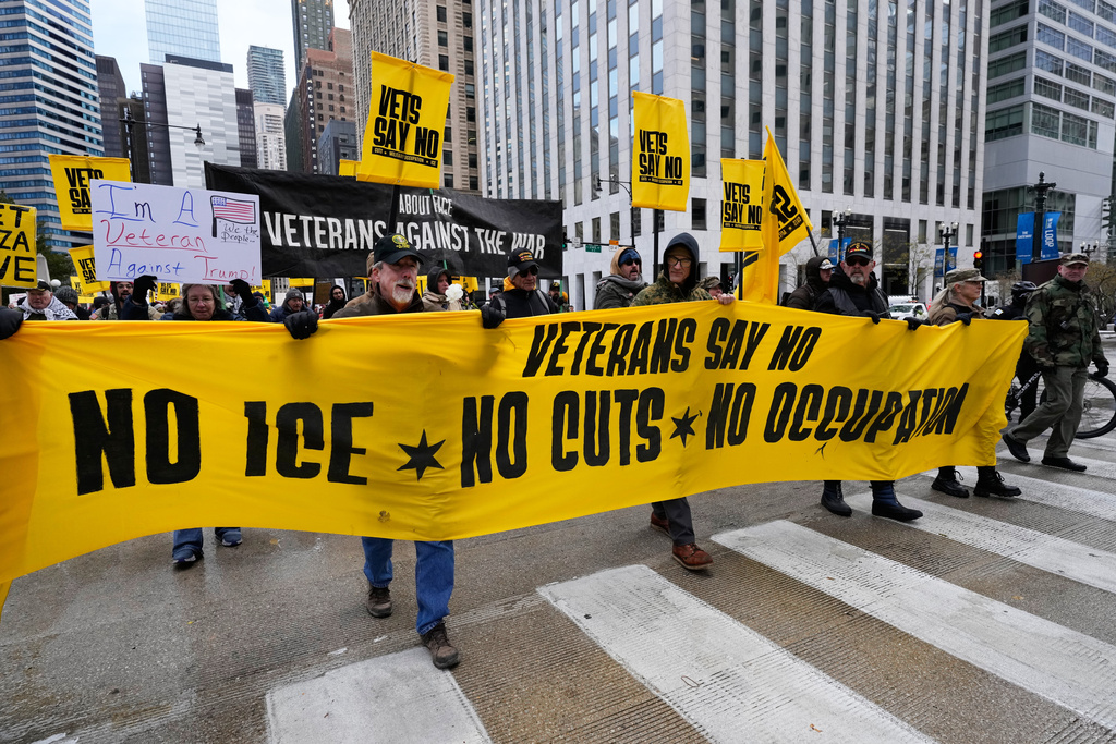 People march during veterans protest in Chicago, Tuesday, Nov. 11, 2025. (AP Photo/Nam Y. Huh)